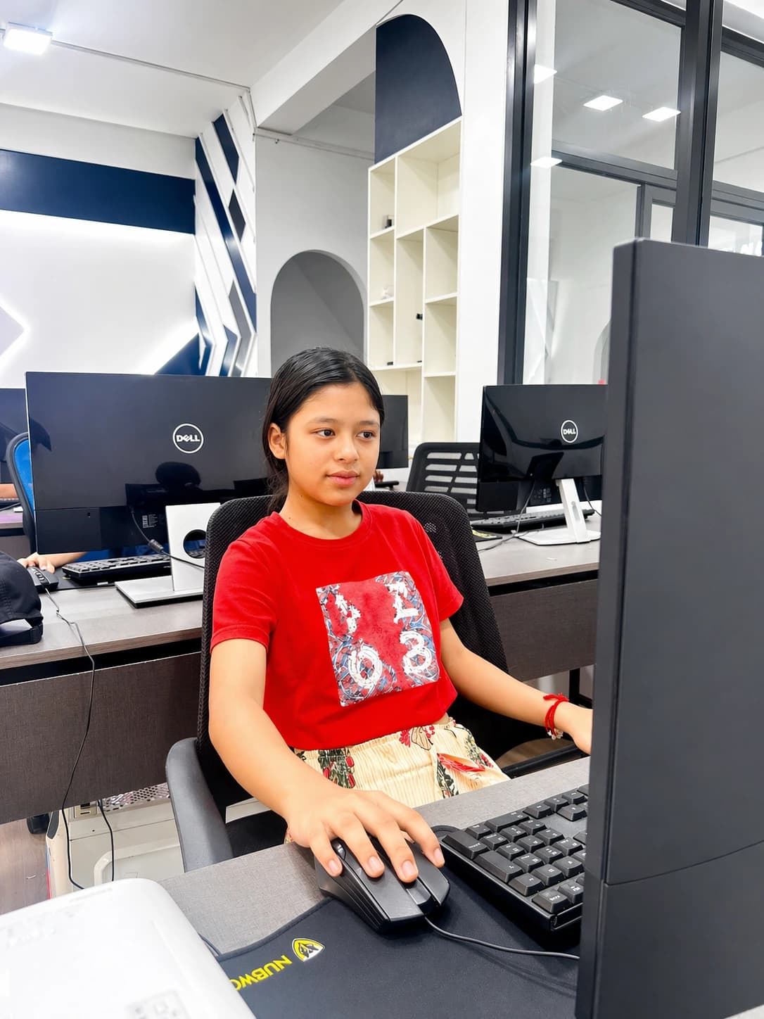 Young Nura Dev learner practicing computer skills in the lab