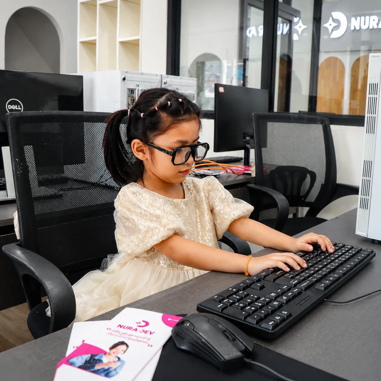 Young Nura Dev student practicing typing in the computer lab