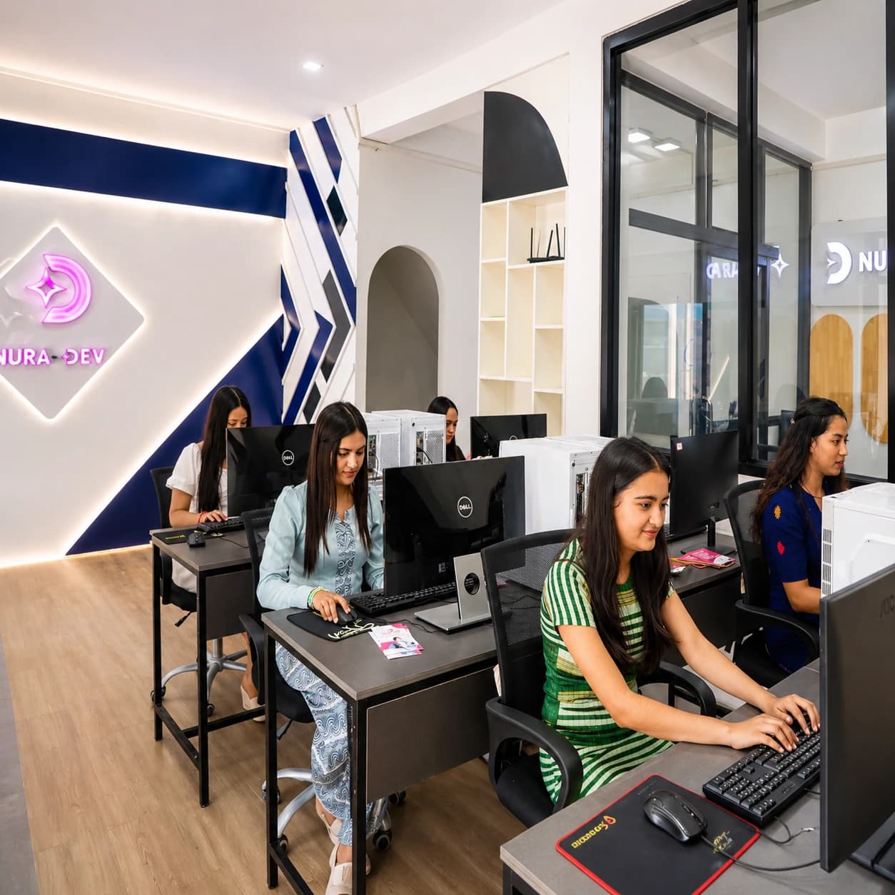 Students learning practical computer skills in the Nura Dev classroom