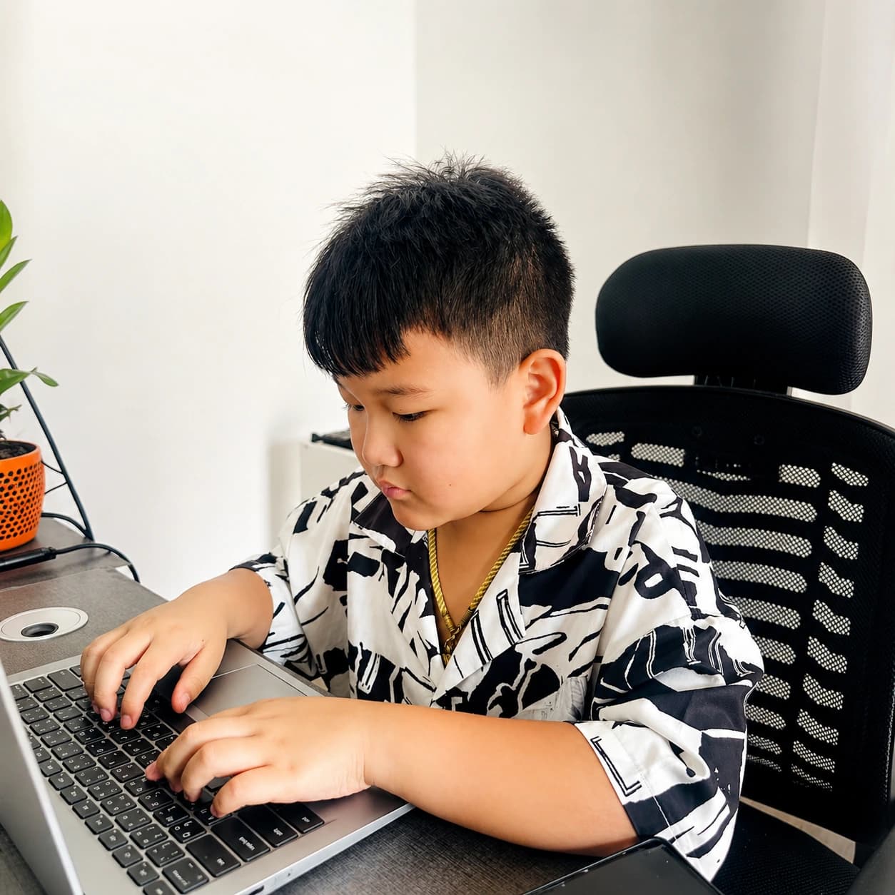Young student typing on a laptop during Nura Dev computer training