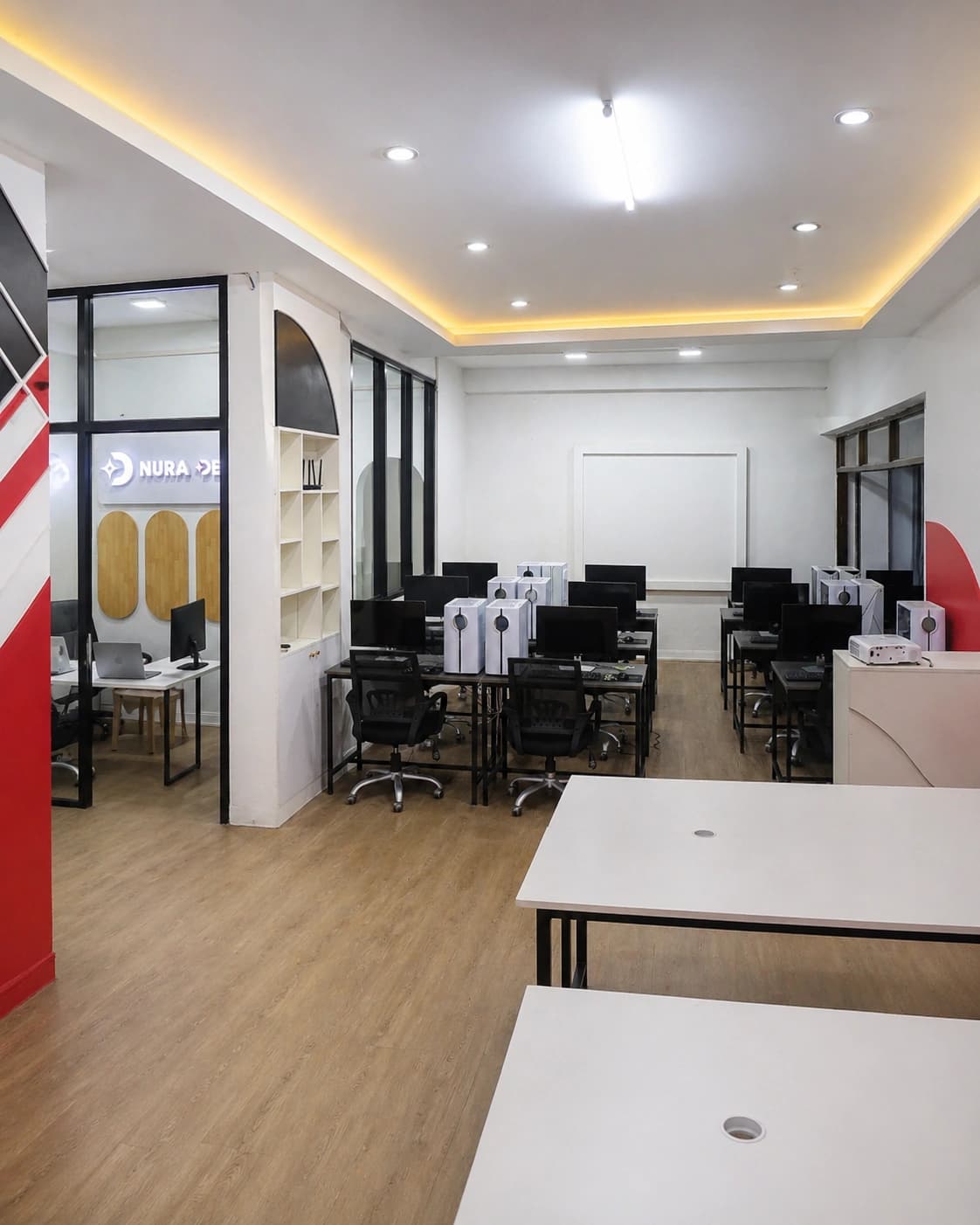 Nura Dev computer classroom with desktop workstations and campus learning space